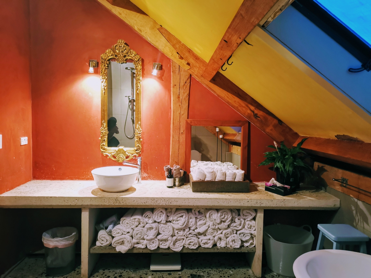 Photo of property: Enjoy the industrial styled bathroom with its rainfall shower, antique claw bath, gilded mirror over the white cement bench and under floor heating