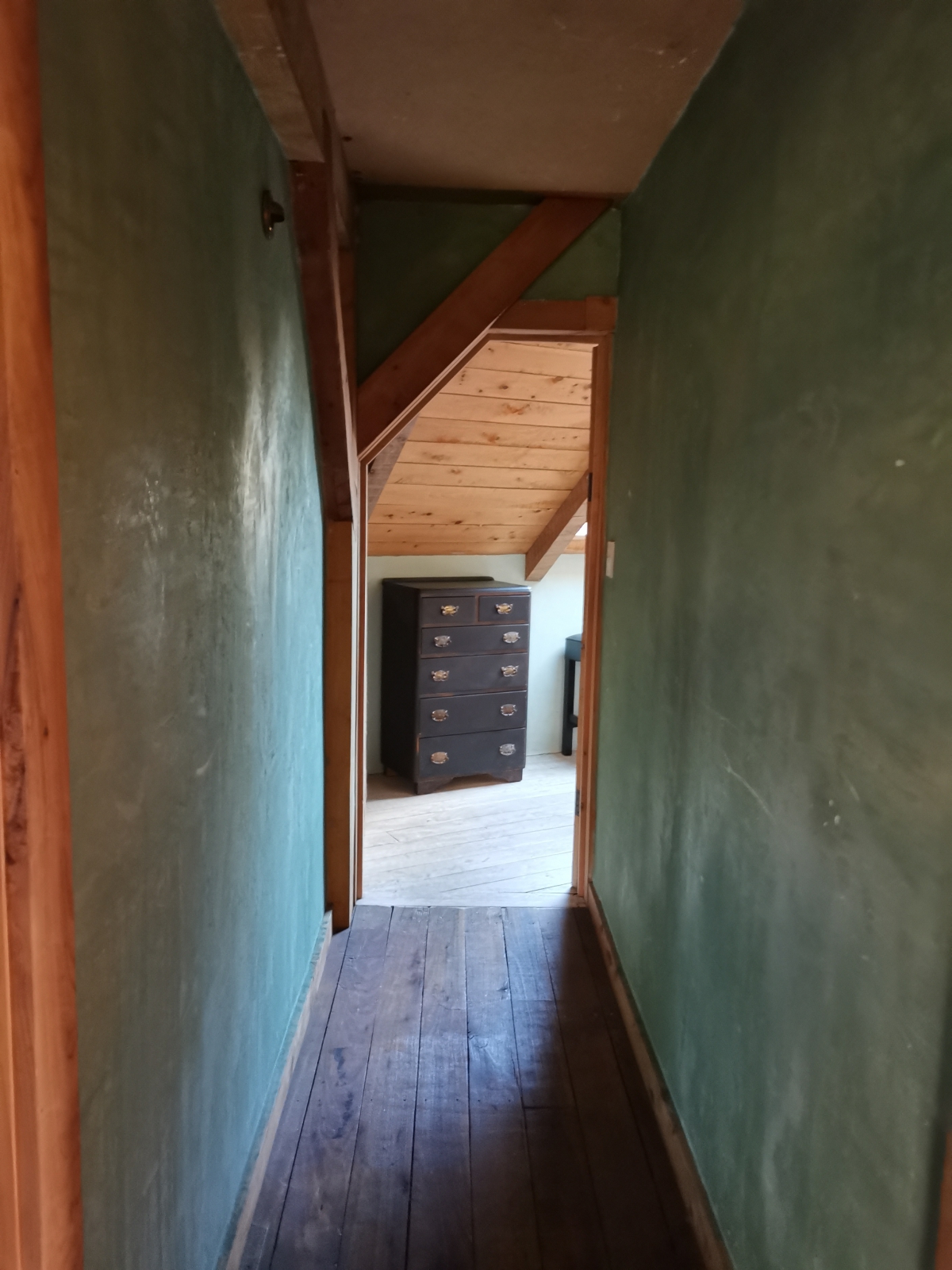 Photo of property: access to the wing is off the main passageway on the second level, opening into the first of two rooms divided by a door