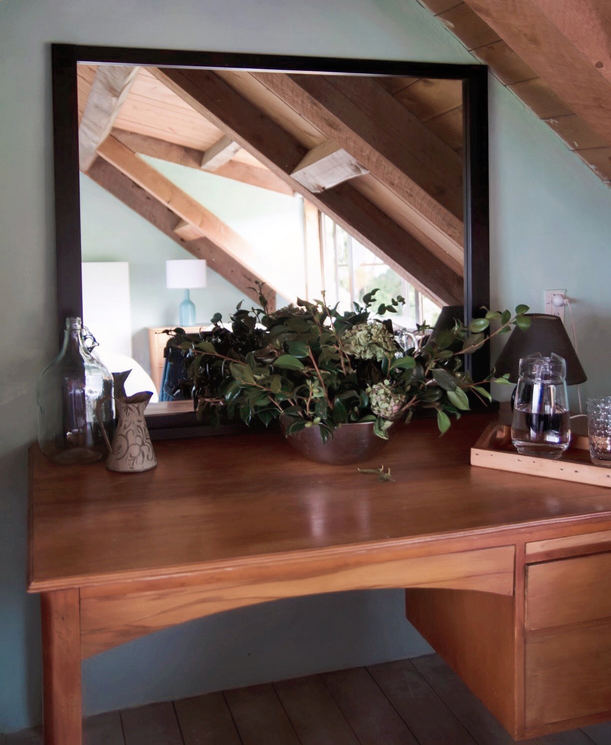 Photo of property: a large wooden desk and mirror adds a pleasing aesthetic to the wing, offering a facility to groom