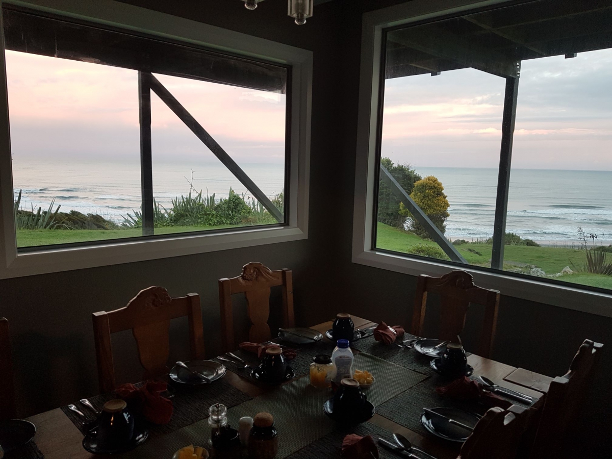 Photo of property: Breakfast table set from dining room with views to Tasman Sea on sunrise