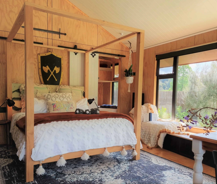 Photo of property: This cabin has been custom designed for your perfect holiday and features a unique and cosy interior with a handmade 4 poster bed and a single and double bunk in the attached room. Sleeping 5 with the option of a 6th person sleeping on the generous window seat.