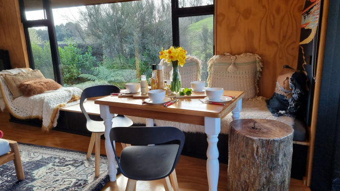 Photo of property: Drink in the winter afternoon sun at the indoor dining table. Or dine Al Fresco at outdoor picnic table down under the Paulownia tree at the river.