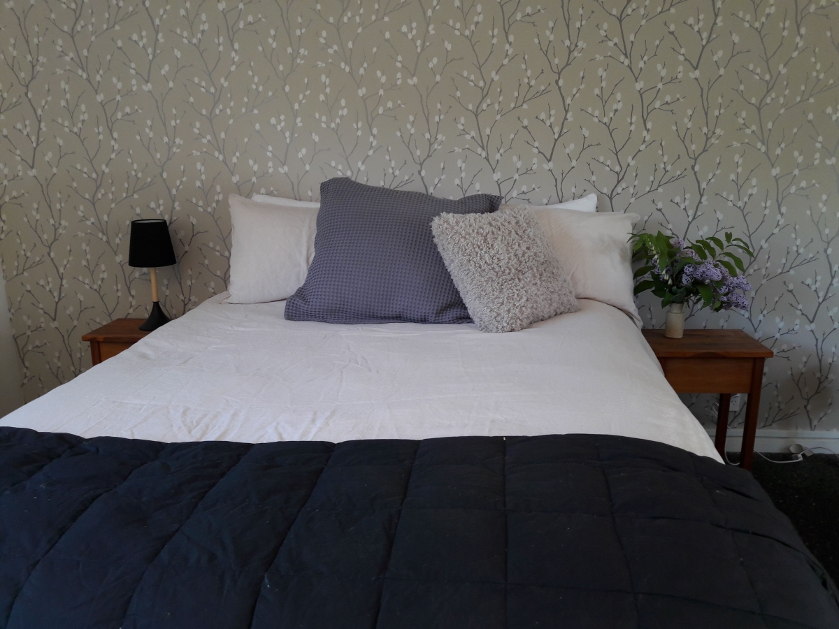 Photo of property: comfy queen bed with beautiful wallpaper 